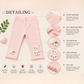 Pink baby leggings with detailing on a light pink background