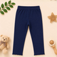 Navy blue leggings on a beige background with decorative elements.