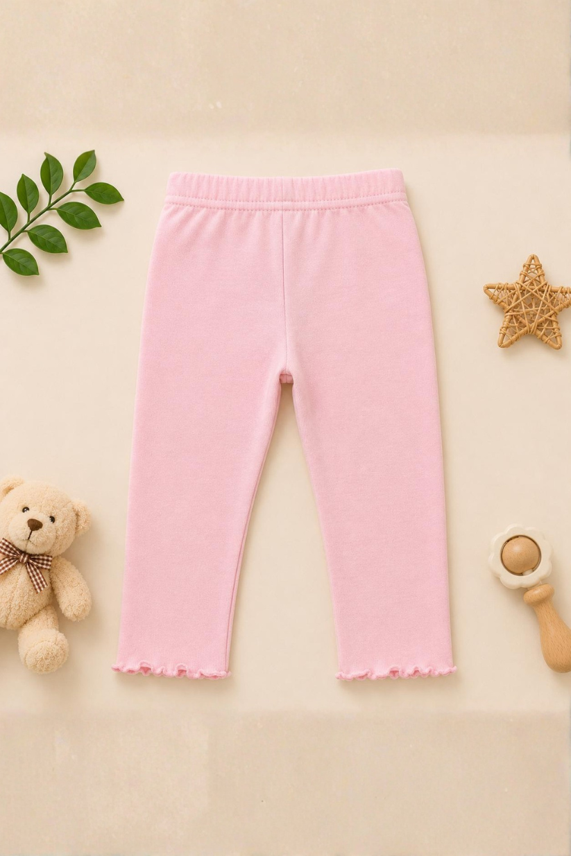 Pink pants on a beige background with a teddy bear and star decorations.
