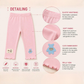 Detailed view of pink baby pants with text on a light pink background