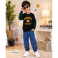 A 3-year-old boy modeling a black long-sleeve shirt with green plaid sleeves and yellow 'MINNESOTA 1895 ON DUTY' text, paired with blue jeans and white sneakers in a styled room setting.