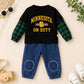 A toddler boy's two-piece outfit set featuring a black long-sleeve shirt with green plaid sleeves and yellow 'MINNESOTA ON DUTY' text, paired with blue denim pants.