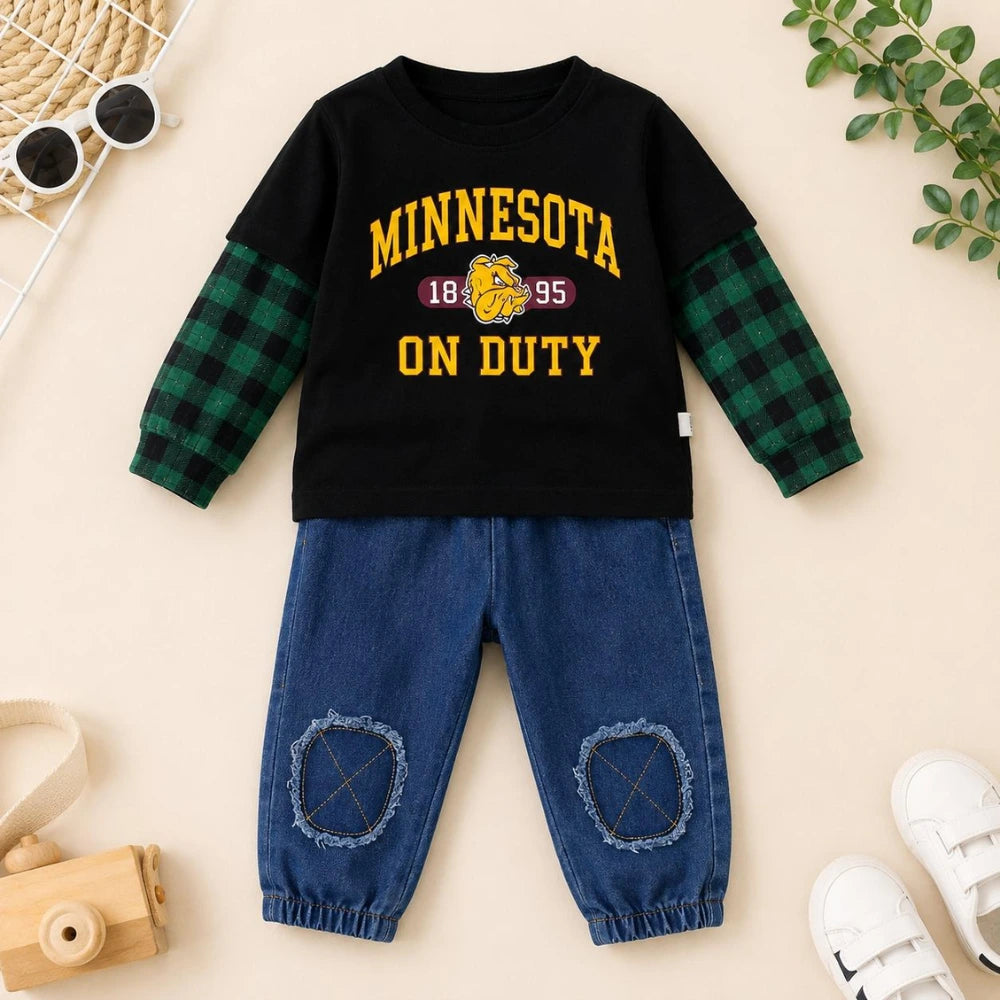A toddler boy's two-piece outfit set featuring a black long-sleeve shirt with green plaid sleeves and yellow 'MINNESOTA ON DUTY' text, paired with blue denim pants.